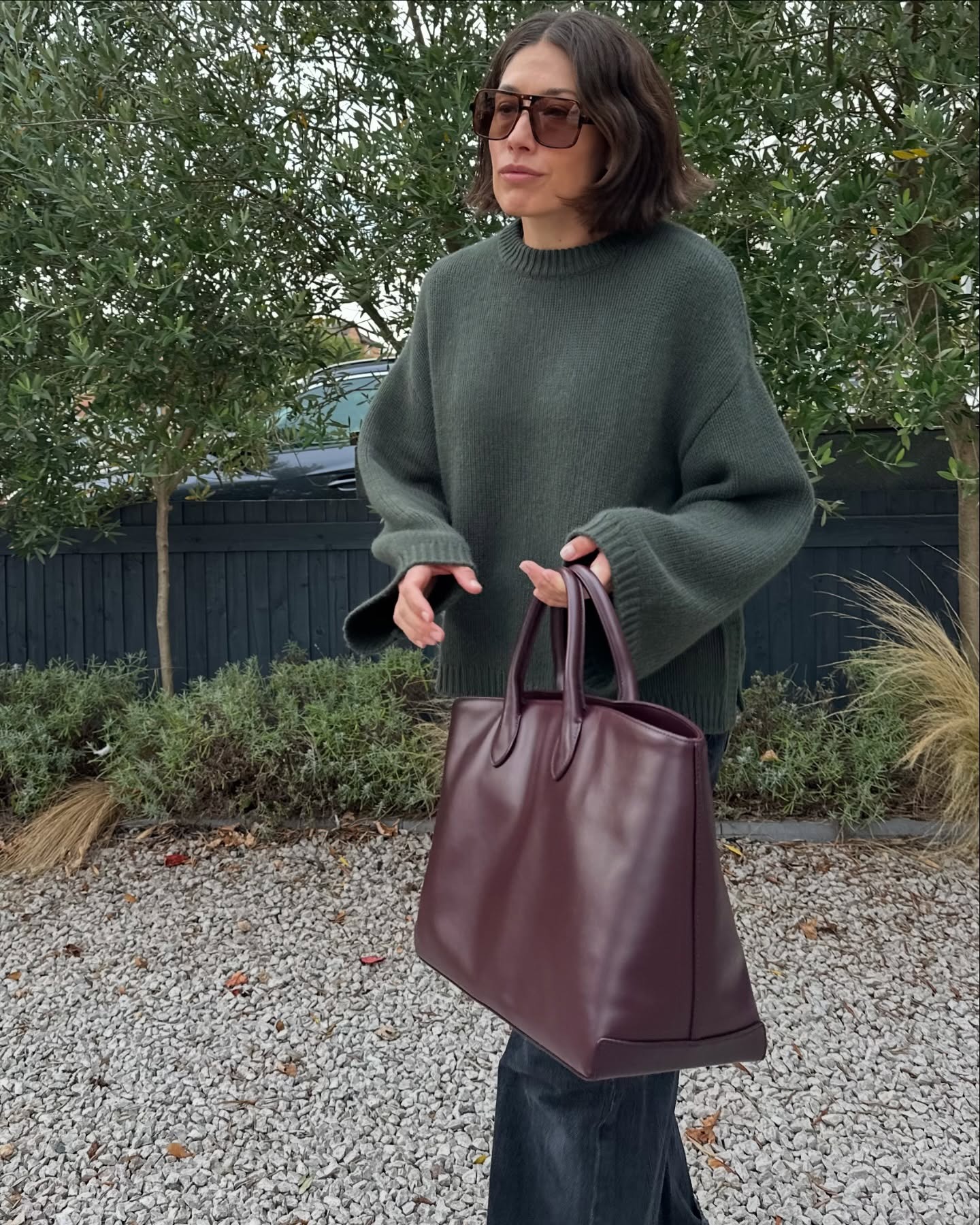 Woman in green crewneck sweater.