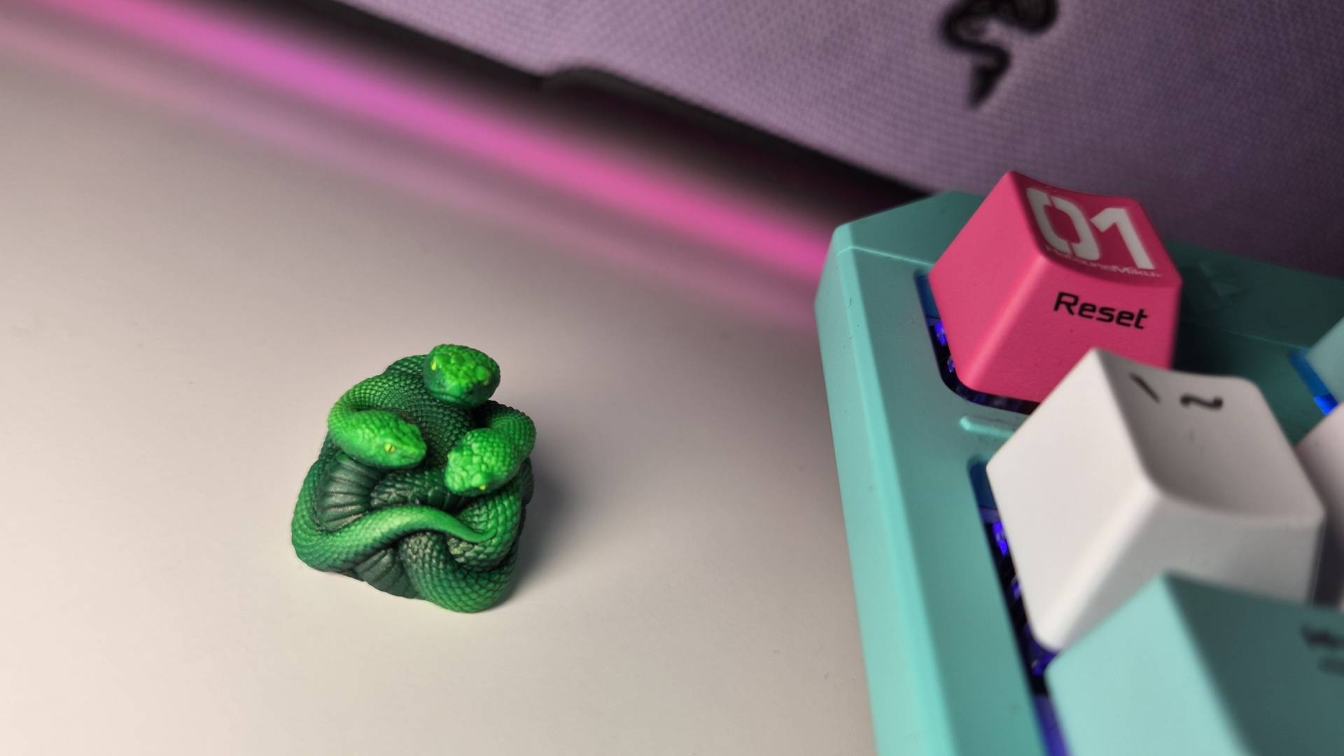 Photo of the Razer Artisan Keycap sitting next to a Hatsune Miku keyboard.