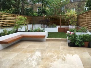 lawn ideas: paving and raised lawn in small garden