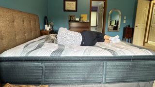 Tom's Guide's mattress tester laying on top of the Beautyrest Harmony Lux mattress