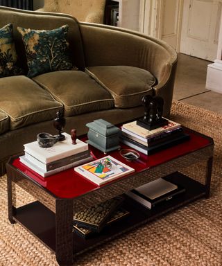 Red and black lacquer coffee table with olive green velvet curved sofa