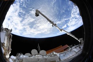 The Canadarm2 robotic arm is fully extended in this photo by Canadian Space Agency astronaut David Saint-Jacques. 