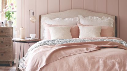 Bedroom with a breakfast tray on the bed and macrame wall decoration