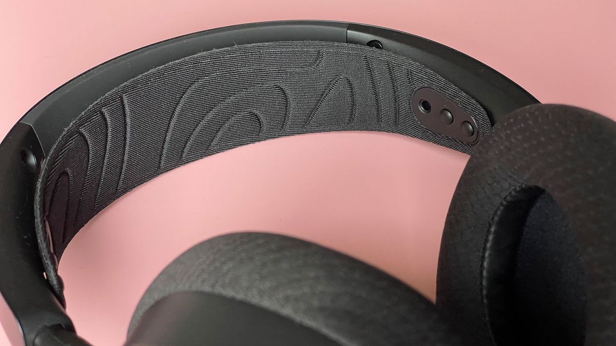 The SteelSeries Arctis Nova 7 Wireless on a pink background.