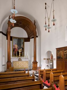 Fig 1: The high altar with its tall baldacchino. Note the cardinal-hat lights. Campion Hall, University of Oxford. Photographed by Will Pryce for Country Life. ©Country Life