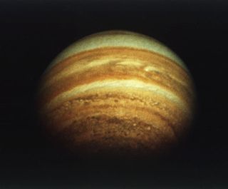 The planet Jupiter as seen from above its north pole by Pioneer 11. The pole itself is roughly on the line of the terminator (boundary between Jovian day and night).