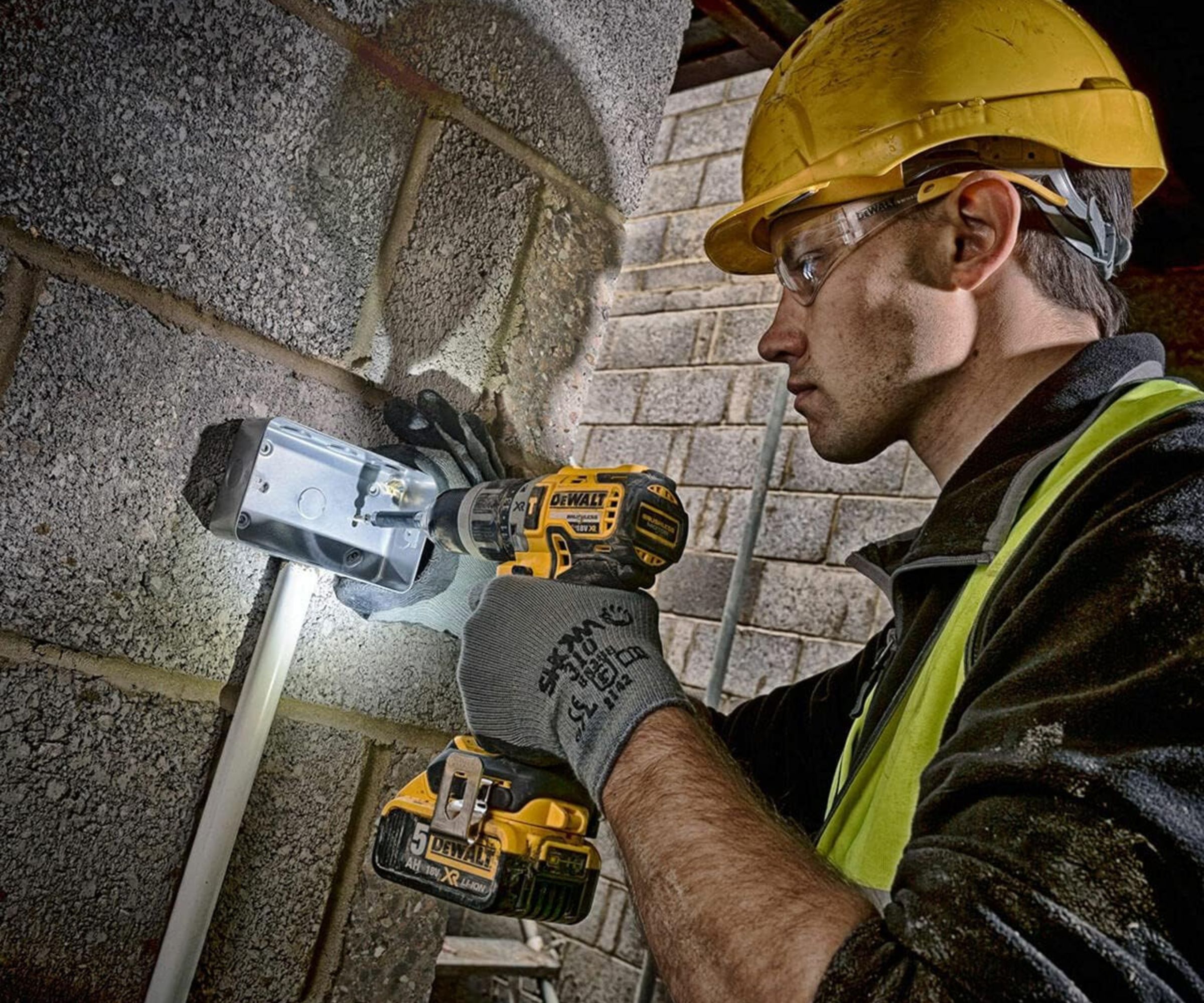 DEWALT DCD796P1-GB XR Brushless Compact Lithium-Ion Combi Drill being used on masonry