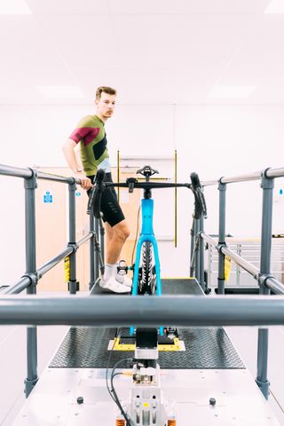 a man looks at a bike in a lab