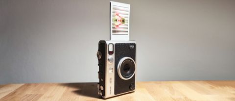 The Fujifilm Instax Mini Evo on a wooden table