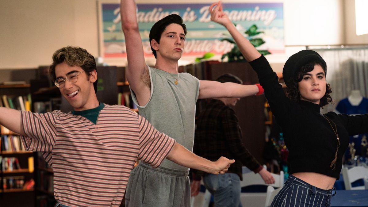 L-R: Nick Pugliese as Charley, Milo Manheim as Wally Clark and Sarah Yarkin as Rhonda all dancing by putting their left arms straight up in the air and holding their right arms to the side.