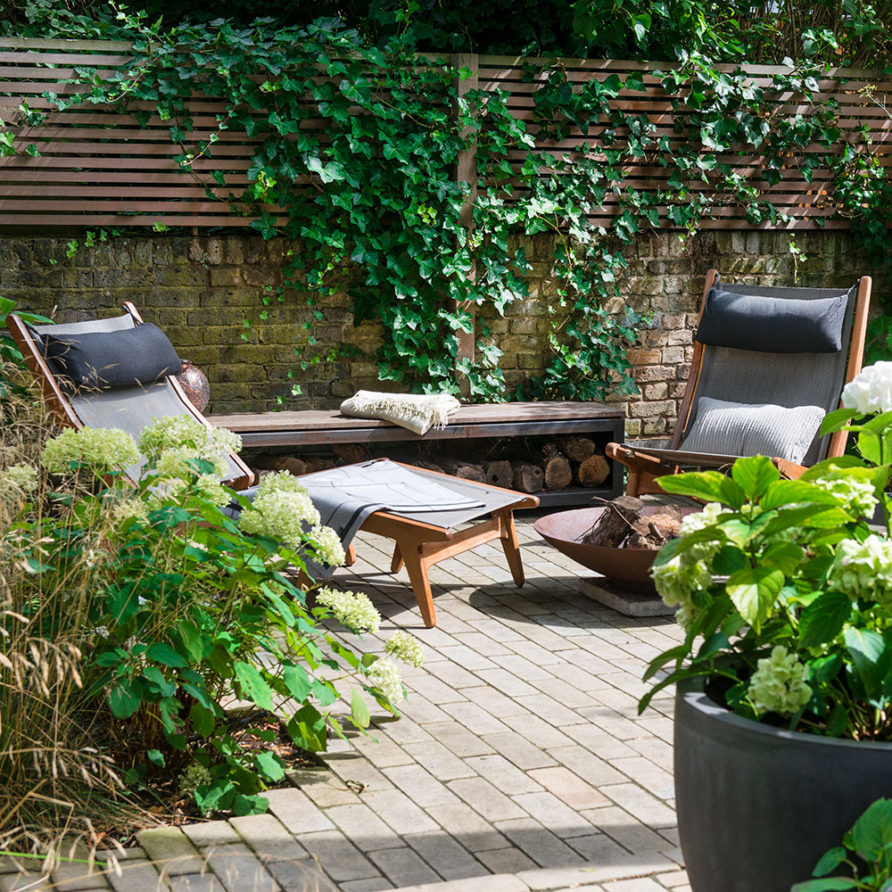 balcony garden with bricked flooring plant in pots and rocking chairs