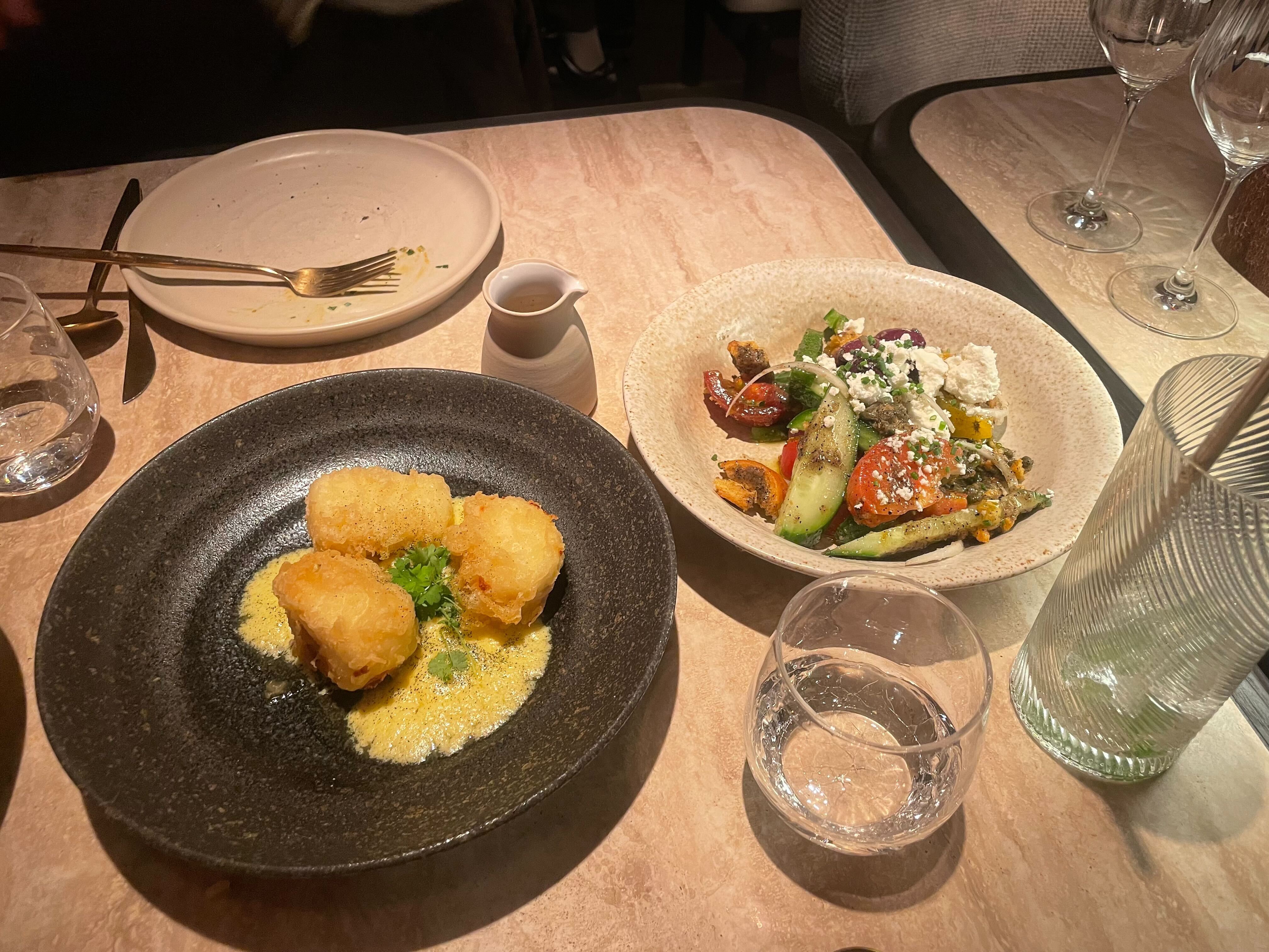 an image of two of the dishes at Fenix in Mayfair, with the Mykonian salad on the right