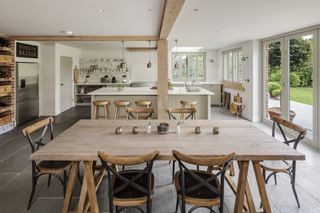 grey kitchen with oak frame and rustic dining table