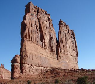 Sandstone fins are formed when sandstone domes collapse and are then eroded and weathered into a maze of vertical rock slabs