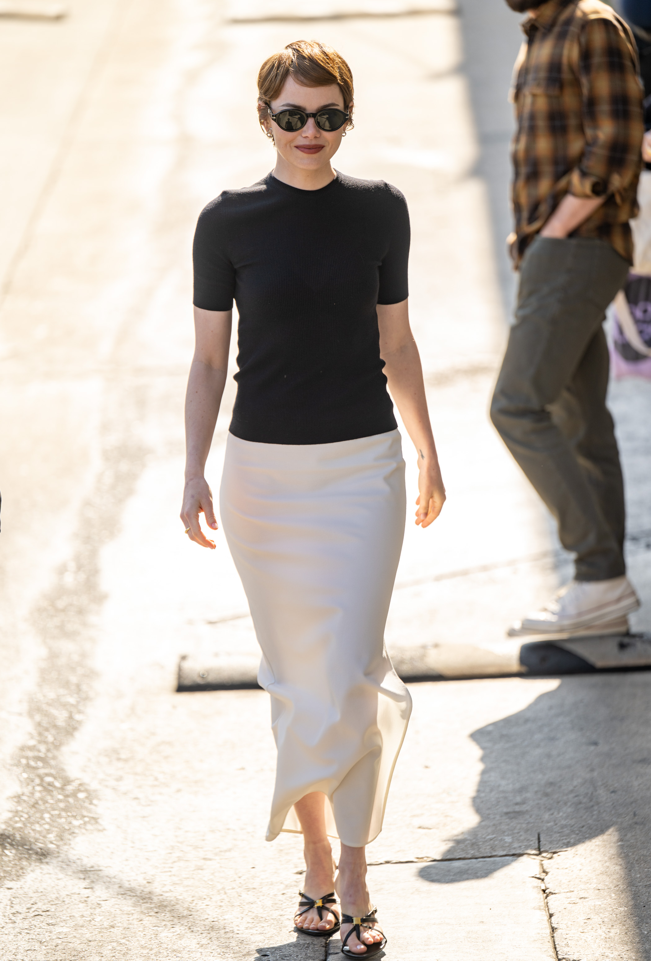Emma Stone wore the white satin skirt trend in June 2025