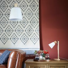 room with burgundy wall and lamp