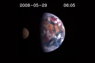 Scientists might one day be capable of discerning land, oceans and clouds on distant planets by looking for reddish, bluish or grayish tints in the color of those worlds. Above is a still image from the EPOXI mission showing the Moon transiting Earth. They are observed at different light wavelengths, which is why differences in details are visible. The first pictures of an Earth-like extrasolar planet will not be this detailed.