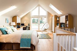 Bedroom with home office and built in storage above a garage conversion
