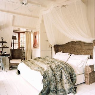 master bedroom with headboard white canopy