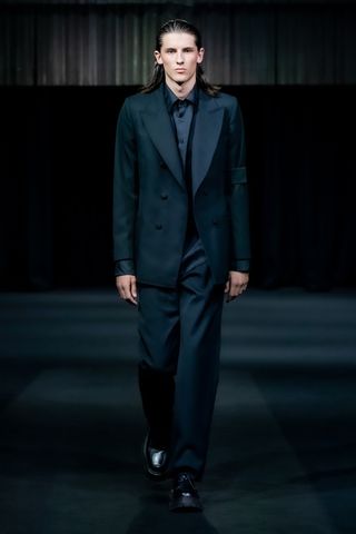 Model wears black suit by Daniel W Fletcher at London Fashion Week S/S 2023