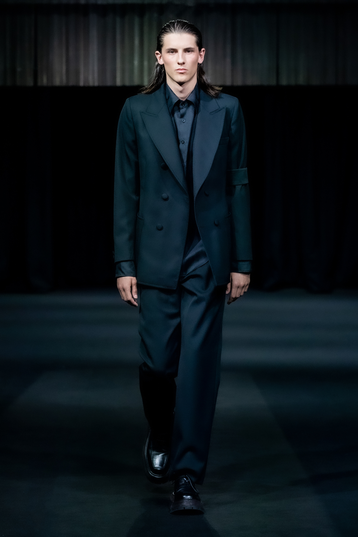 Model wears black suit by Daniel W Fletcher at London Fashion Week S/S 2023