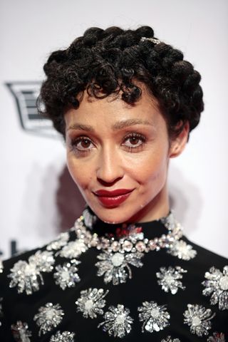 A woman, Ruth Negga, with short curly hair.