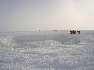A crater in the snow. Underneath lies the collapsed remains of 'Old Pole', the affectionate term used for the first U.S. Amundsen-Scott station at the South Pole.