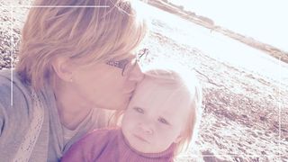 image of a mum and baby on the beach