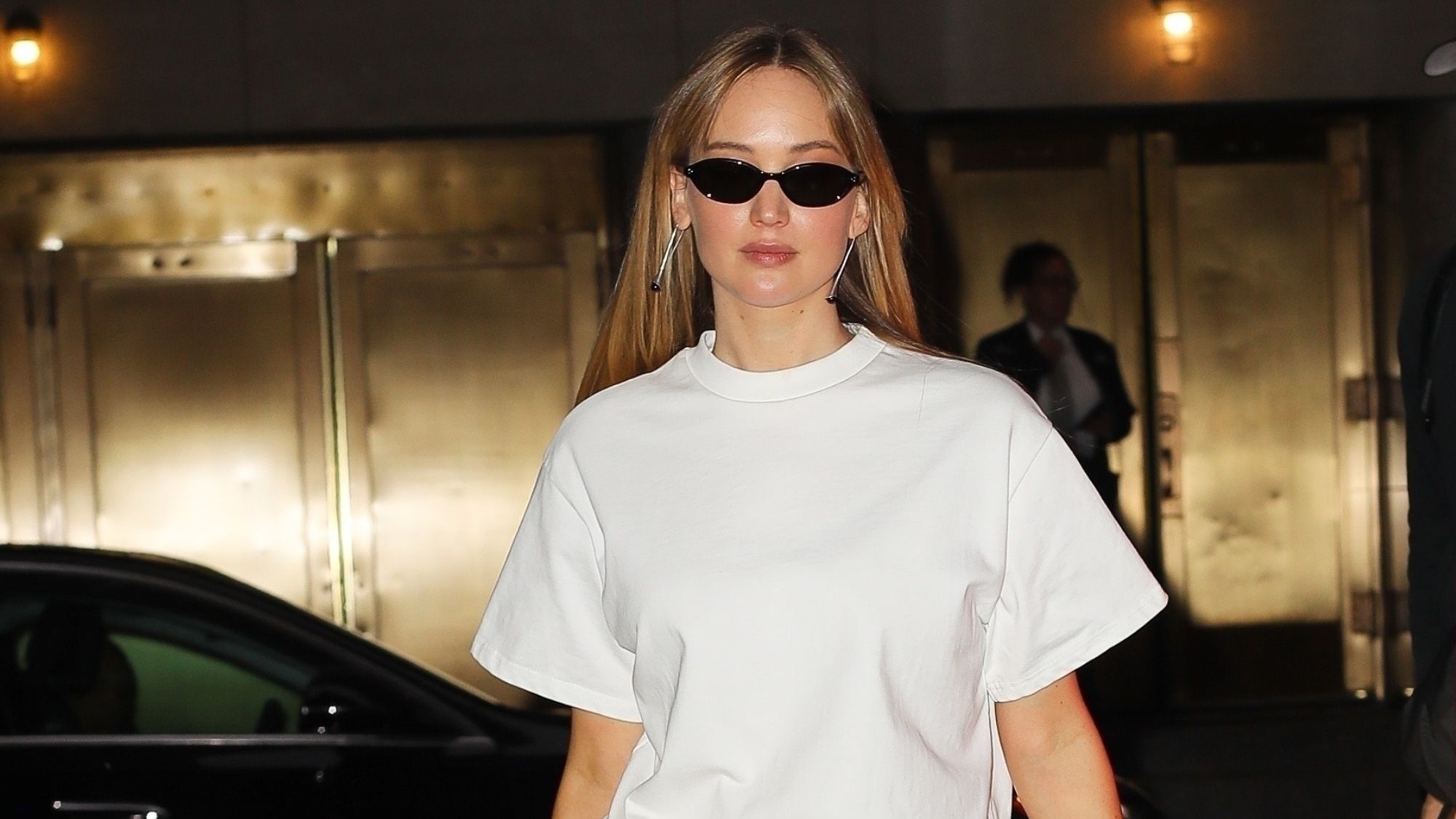 jennifer lawrence wears a white tshirt, black skirt and bow heels in new york city