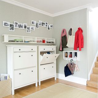 hallway with photo frames and wall mounted cabinets