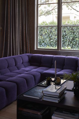 A purple couch in a small living room