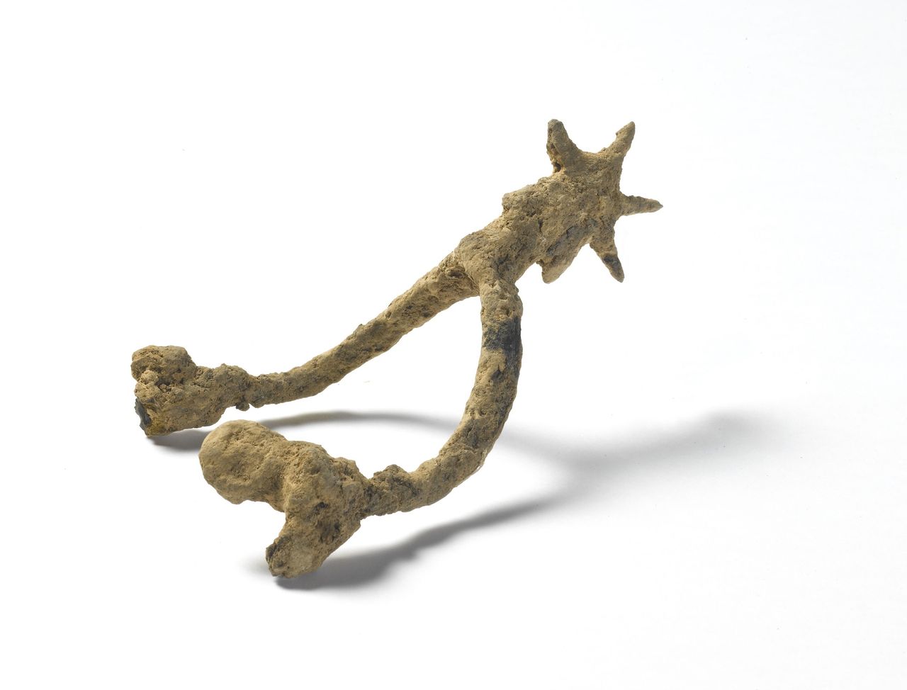 This corroded 14th-century iron spur would have been attached to the back of a boot for horse riding.