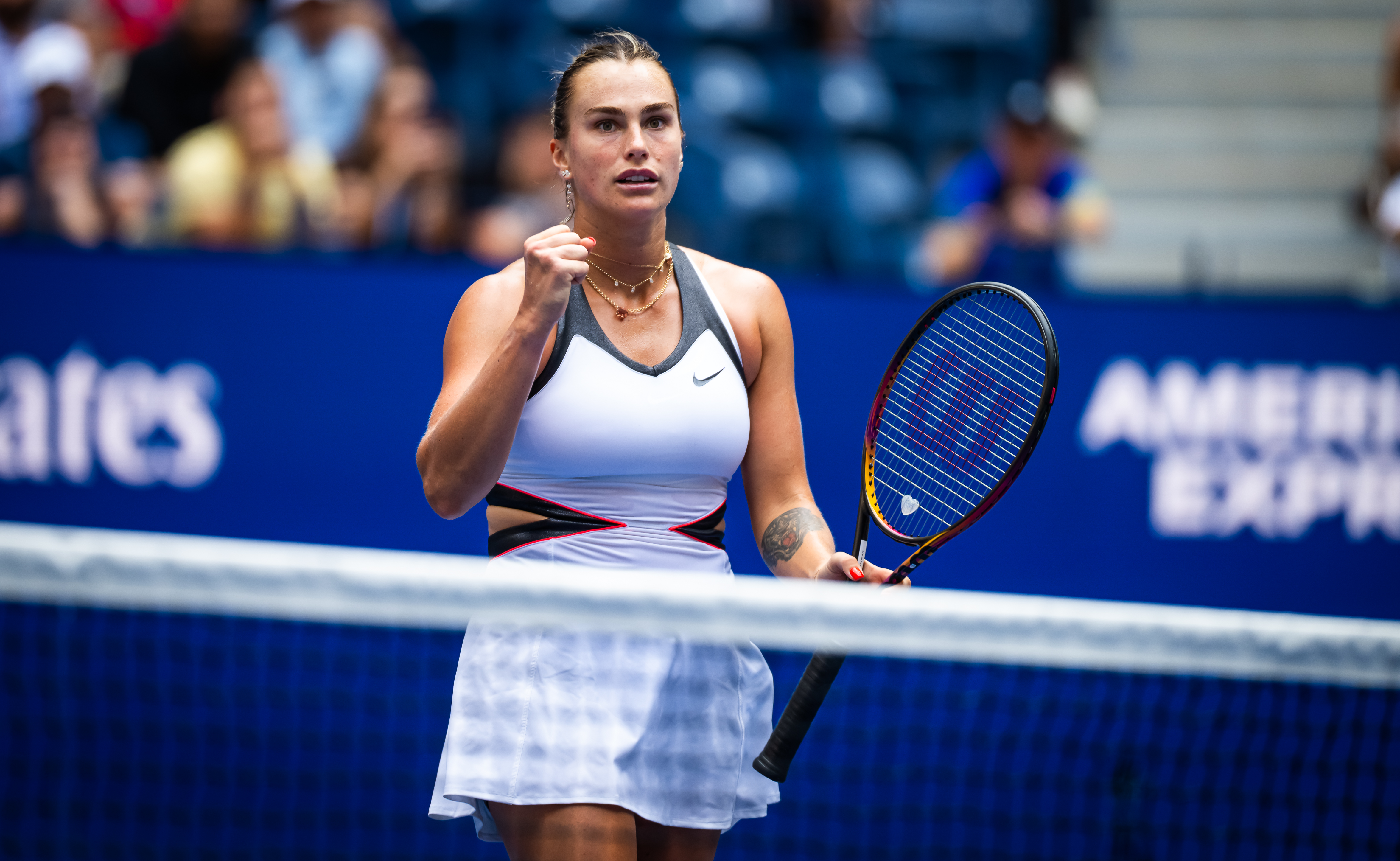 a tennis player wears a cut-out nike dress with a necklace stack
