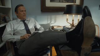 Tom Hanks, as the Washington Post editor in chief, kicks his feet up on his desk in The Post