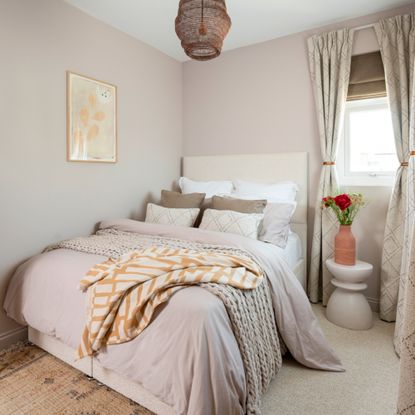 bedroom with bed and roman blinds