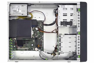 The motherboard comes from the TX120 S3 desktop server and looks tiny inside the vast interior of the TX140 chassis.