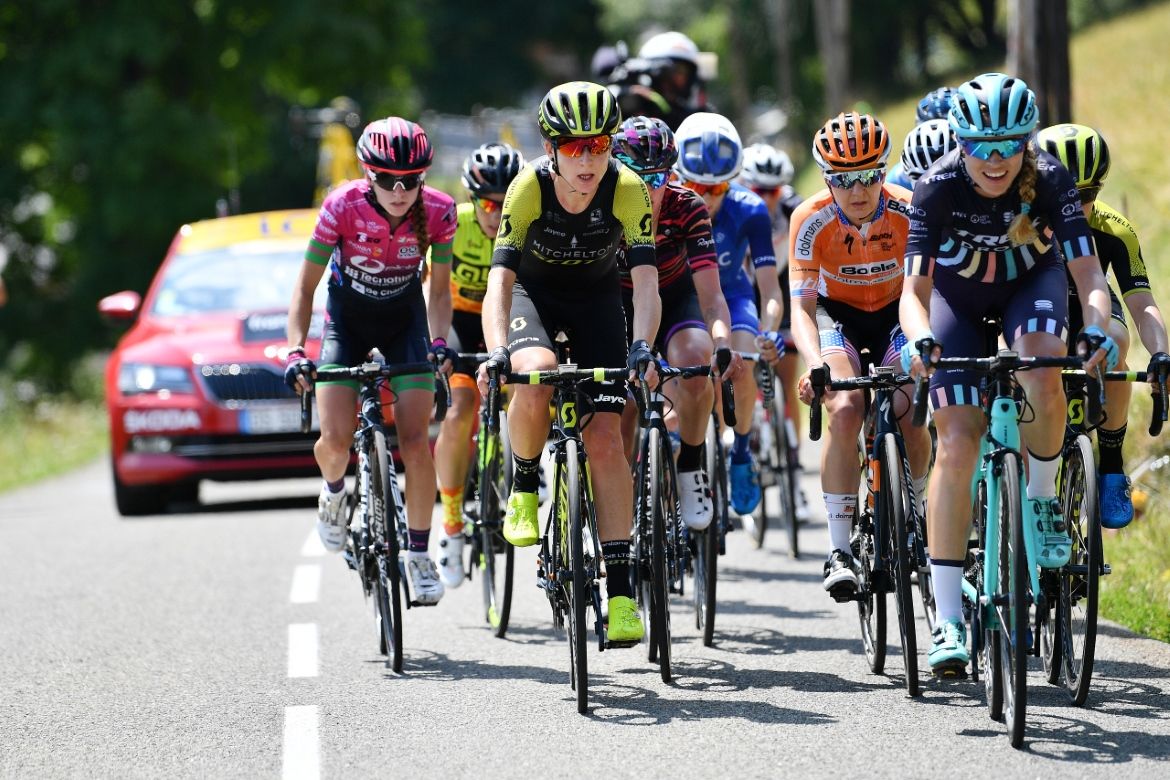 The peloton thins out as the road heads uphill