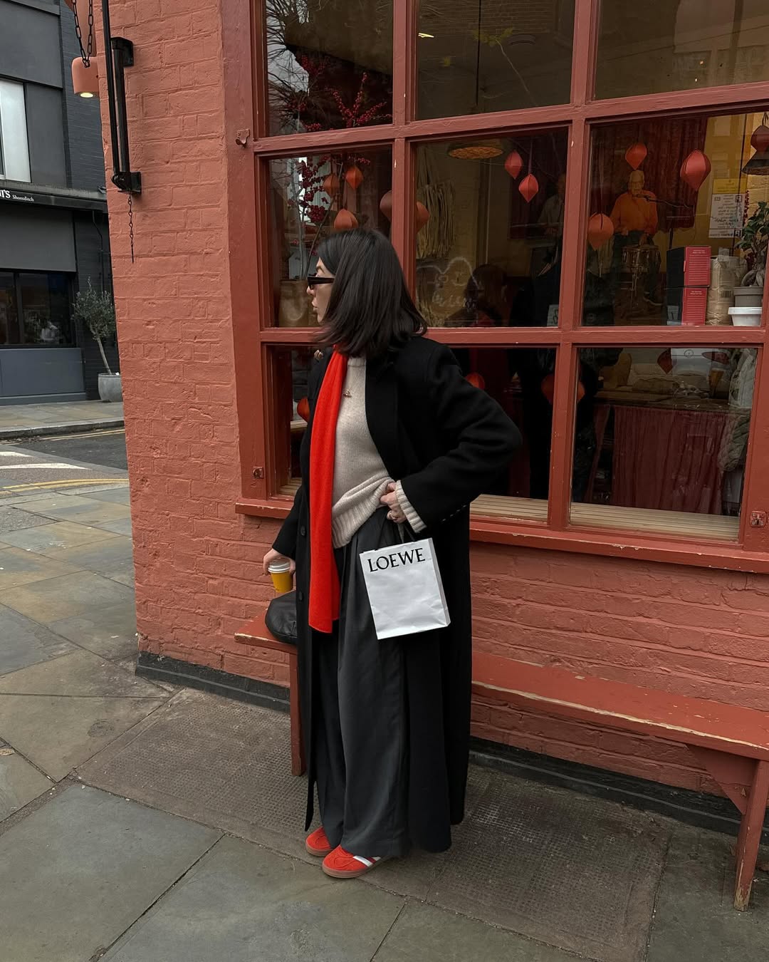 @francescasaffari wearing red trainers with black trousers