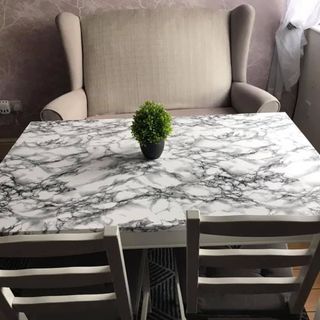 room with marble table and dining table