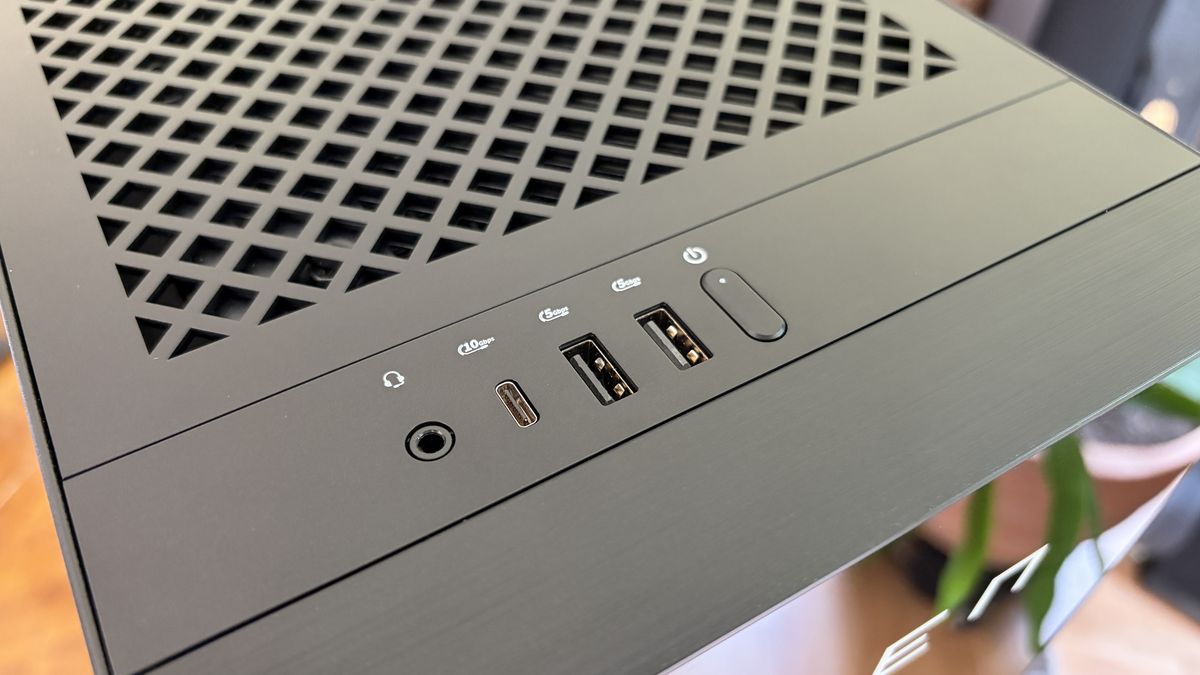 Top view of an Omen Max 45L computer case featuring a grid vent, USB ports, and a power button in a home setting.