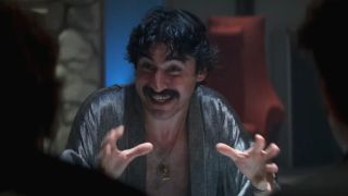 A crazed Alfred Molina raises his hands in conversation in Boogie Nights.