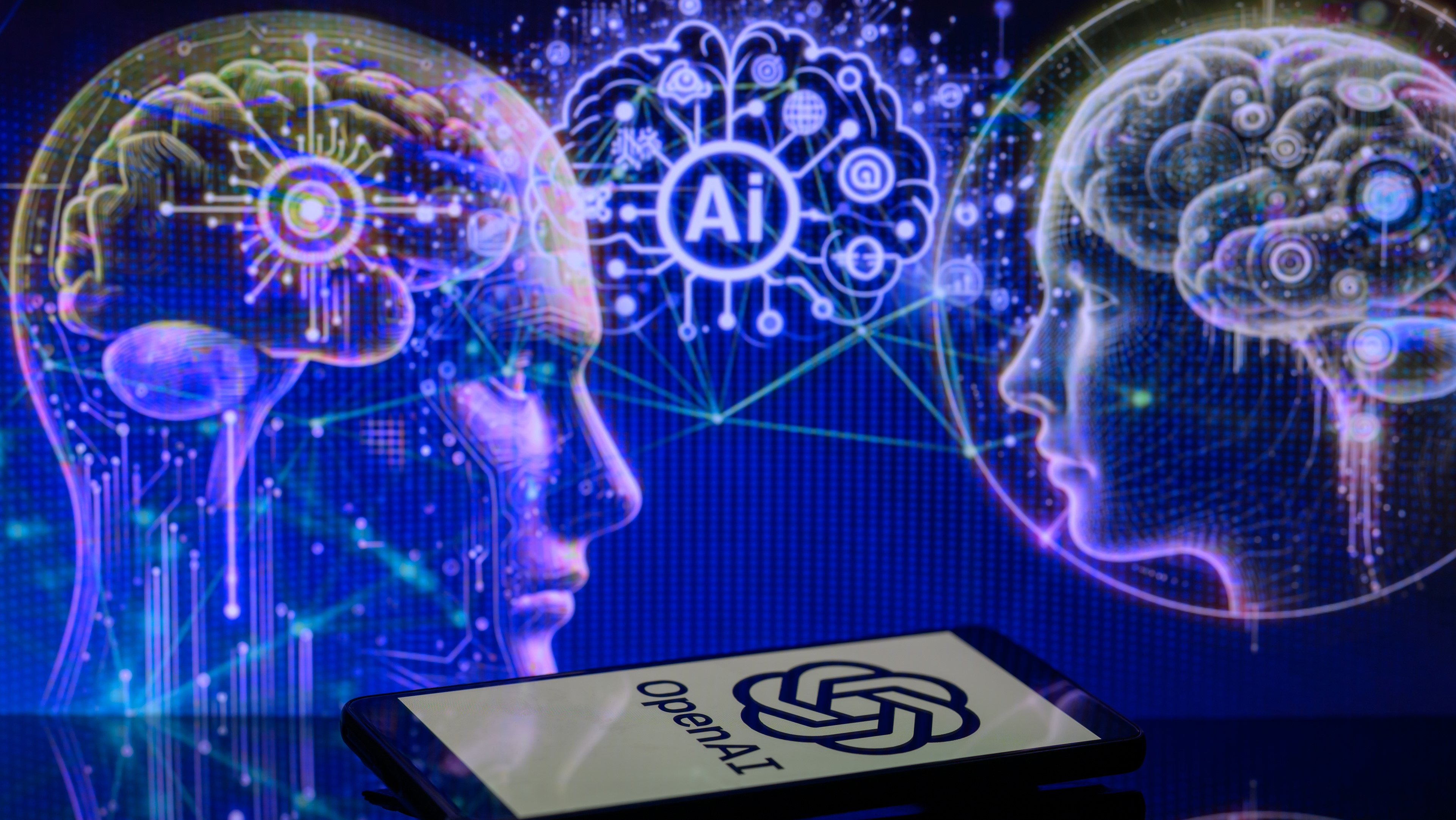The OpenAI logo is being displayed on a smartphone with an AI brain visible in the background, in this photo illustration taken in Brussels, Belgium, on January 2, 2024. (Photo illustration by Jonathan Raa/NurPhoto via Getty Images)