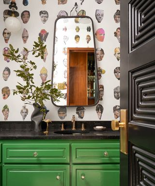 cloakroom bathroom with green vanity and whacky wallpaper