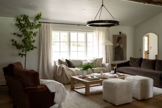 a modern white living room with three different colored couches