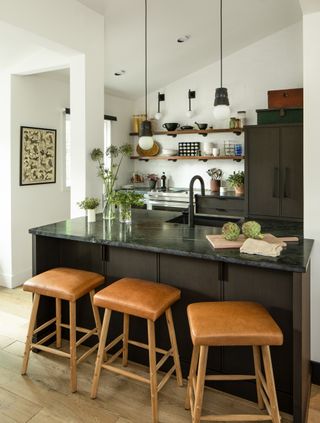 white kitchen with black kitchen island by Liz Caan