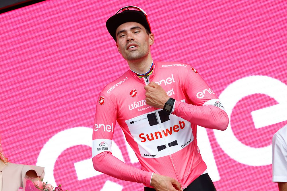 Tom Dumoulin pulls on the pink jersey after winning the opening time trial at the 2018 Giro d'Italia