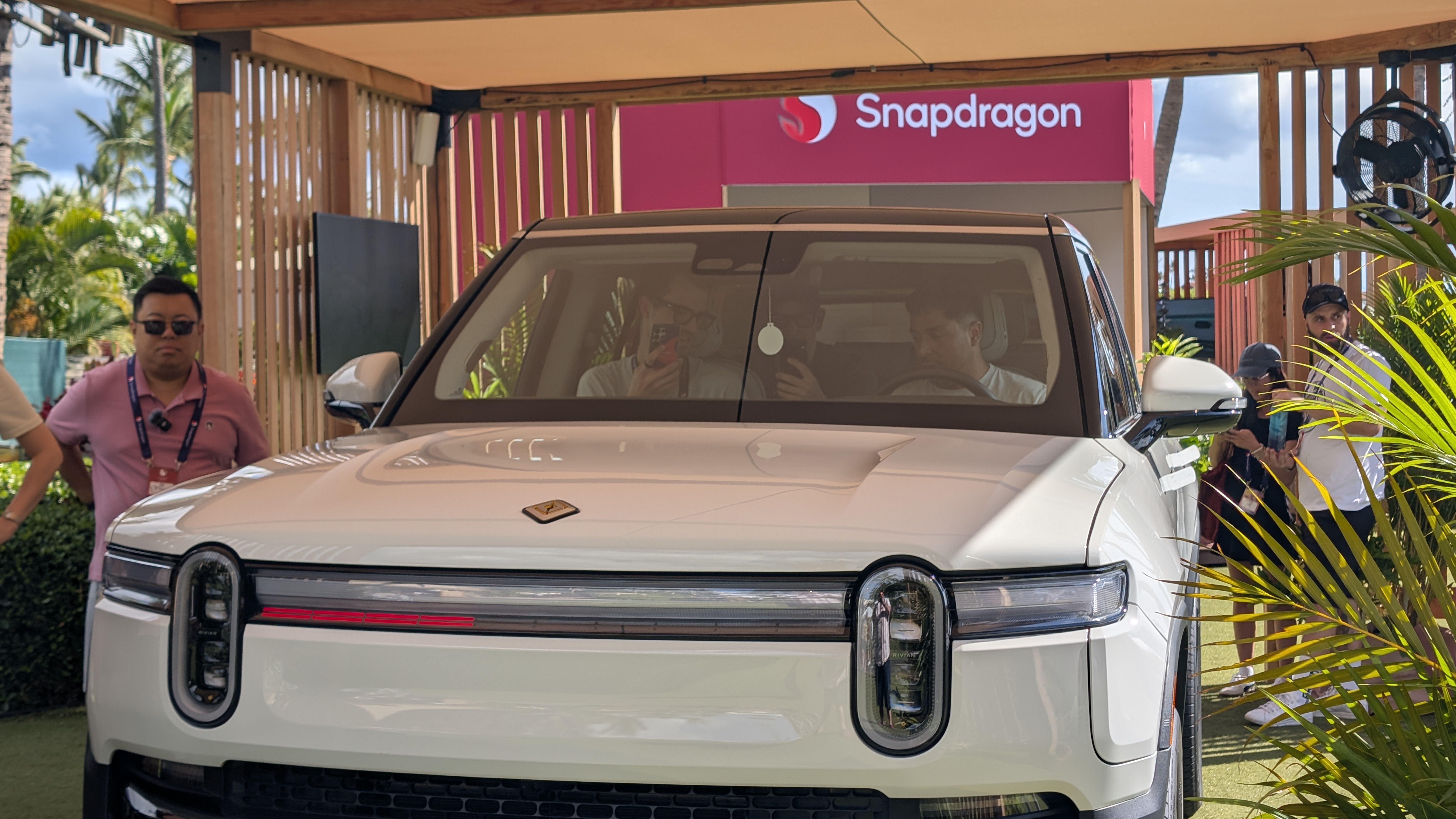 Rivian R1S truck beneath a Snapdragon logo