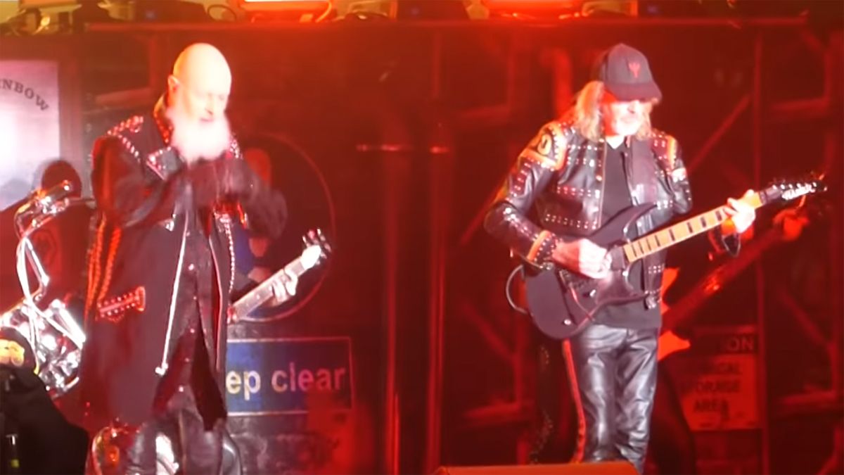 Glenn Tipton (right) performing live alongside Judas Priest