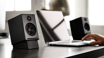 The best computer speakers hero image showing the Audioengine A2+ being used with a laptop on a desk