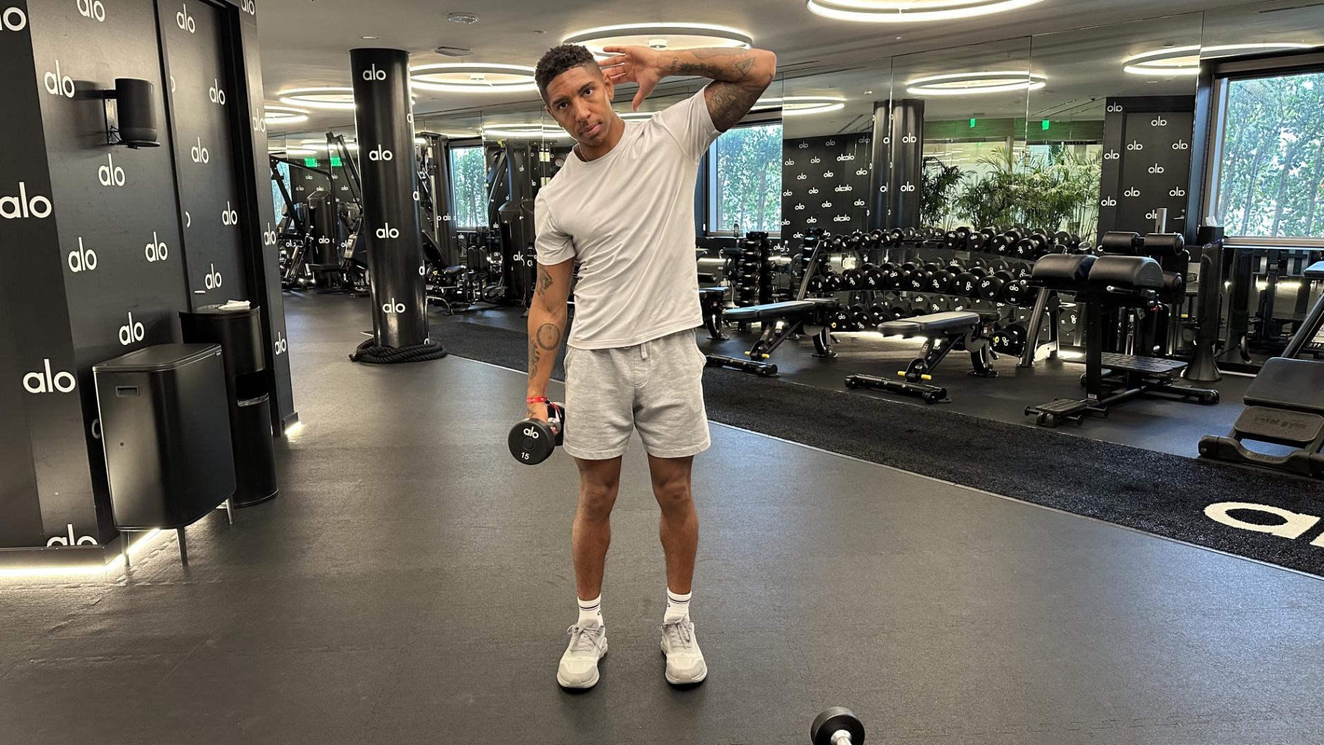 Man exercising with dumbbells in gym